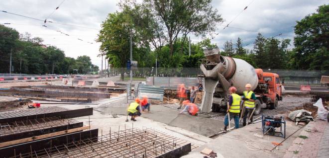 Concrete works for road construction with many workers and mixer machine timelapse