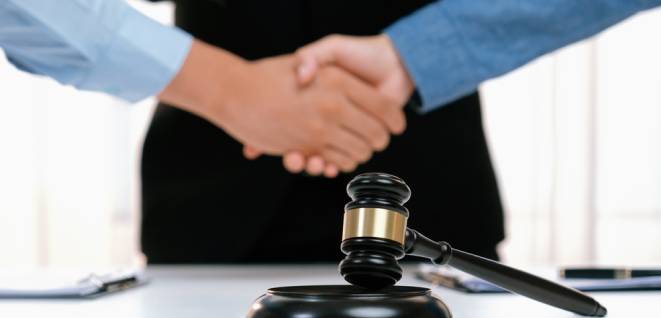 Lawyer acting as legal mediator successfully broke a compromise and seal with handshake between two parties to resolve business dispute