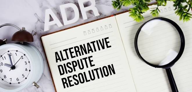 ADR - Alternative Dispute Resolution acronym on notepad